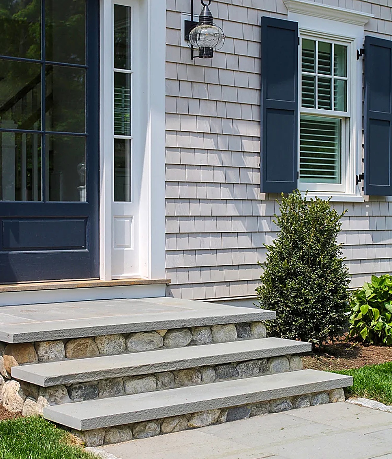 Bluestone front steps with fieldstone risers at a shingle-style home